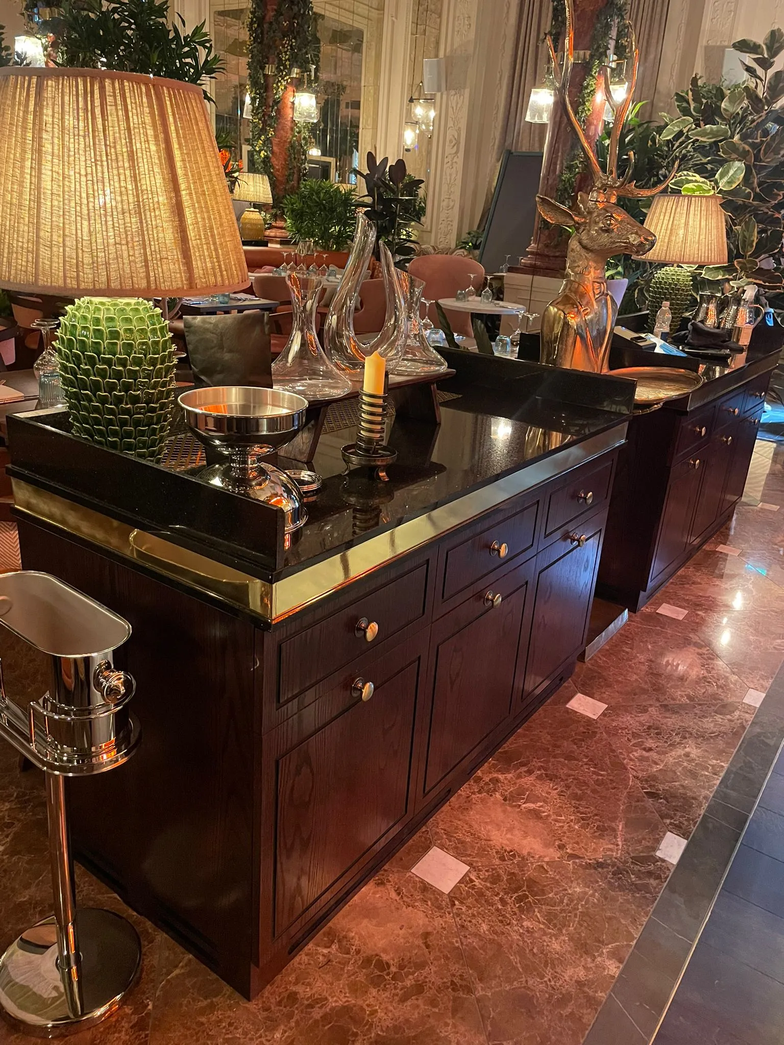 Dark timber waiter stations with brass trim in a restaurant
